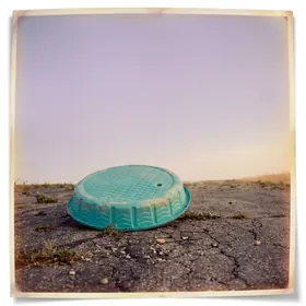 Overturned wading pool on asphalt