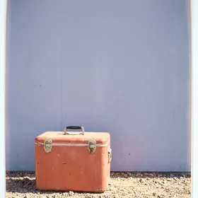 Red cooler on gravel